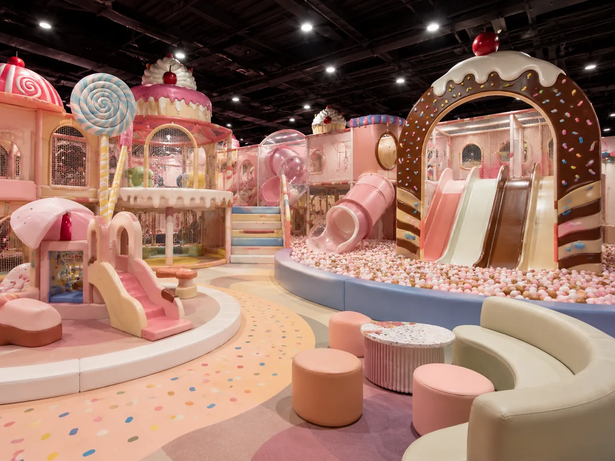 Candy dessert themed commercial indoor playground with pastel slides, ball pit and soft play structures
