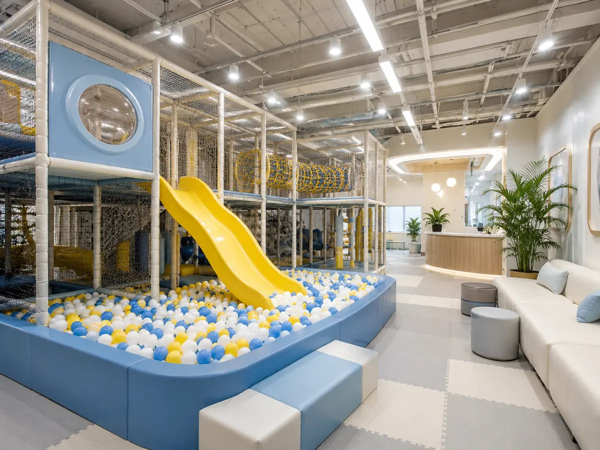 Commercial indoor playground layout with contained play structure, slide, ball area and parent seating